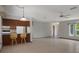 Open living room with kitchen bar, neutral paint, and tile flooring at 8332 Berkeley Manor Blvd, Spring Hill, FL 34606