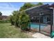 A serene pool with a screen enclosure surrounded by lush greenery, perfect for a peaceful retreat at 8332 Berkeley Manor Blvd, Spring Hill, FL 34606