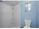 Shower stall with built-in shelving and floral curtain and toilet at 8332 Berkeley Manor Blvd, Spring Hill, FL 34606