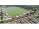 An aerial view of a mobile home community surrounding a lake with condos nearby at 8471 Fantasia Park Way, Riverview, FL 33578
