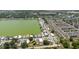 Wide aerial view of a property and its surroundings, showcasing its position within a lakeside community with lush greenery at 8471 Fantasia Park Way, Riverview, FL 33578