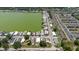 An aerial shot showing the home with a yellow arrow, nestled within a well-planned community near a stunning lake at 8471 Fantasia Park Way, Riverview, FL 33578