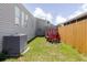 View of the backyard featuring a utility trailer, fence and exterior of home at 8471 Fantasia Park Way, Riverview, FL 33578