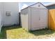 Backyard shed for extra storage space, positioned next to the house and a wooden fence at 8471 Fantasia Park Way, Riverview, FL 33578