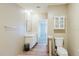 Bathroom features neutral tones, wood-look floors, storage cabinet, vanity, and toilet at 8471 Fantasia Park Way, Riverview, FL 33578