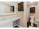 Bathroom featuring a tiled vanity, dark wood storage cabinets and sink at 8471 Fantasia Park Way, Riverview, FL 33578