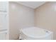 Bathroom featuring a corner soaking tub with white cabinets for storage at 8471 Fantasia Park Way, Riverview, FL 33578