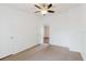 Bedroom with neutral walls and carpet, ceiling fan, showing view to additional room at 8471 Fantasia Park Way, Riverview, FL 33578
