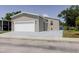 Exterior view of the manufactured home with garage and driveway at 8471 Fantasia Park Way, Riverview, FL 33578