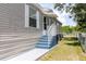 Home exterior featuring a set of blue stairs leading to the front door with freshly painted driveway at 8471 Fantasia Park Way, Riverview, FL 33578