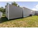 Back of the home and storage shed showcasing the well-maintained lawn and siding at 8471 Fantasia Park Way, Riverview, FL 33578