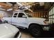 This garage comfortably accommodates two vehicles, complemented by overhead storage and bright, even lighting at 8471 Fantasia Park Way, Riverview, FL 33578