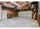 Spacious garage featuring ample storage shelves, a workspace, and a door to the house at 8471 Fantasia Park Way, Riverview, FL 33578