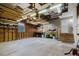Spacious garage with exposed wood beams, fluorescent lighting, and ample storage potential at 8471 Fantasia Park Way, Riverview, FL 33578