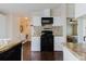 Modern kitchen equipped with a black range and microwave, complemented by mosaic tile backsplash and ample cabinetry at 8471 Fantasia Park Way, Riverview, FL 33578