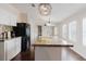 Open kitchen showcasing granite countertops, a spacious island with sink, stainless appliances, and a modern design at 8471 Fantasia Park Way, Riverview, FL 33578