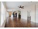 Open-concept living room with wood floors that lead to a modern kitchen with black appliances and ample counter space at 8471 Fantasia Park Way, Riverview, FL 33578