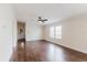 Bright living room boasts stylish dark wood floors, a ceiling fan, and natural light at 8471 Fantasia Park Way, Riverview, FL 33578