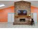 Community lounge area with brick fireplace and mounted television for residents at 8471 Fantasia Park Way, Riverview, FL 33578