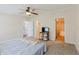 Well-lit main bedroom with carpeted floors, with access to the bathroom and walk in closet at 8471 Fantasia Park Way, Riverview, FL 33578