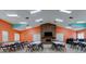 Spacious recreation room with a fireplace, tables, chairs and bright lighting at 8471 Fantasia Park Way, Riverview, FL 33578