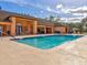 Community pool with lounge chairs for residents to relax and enjoy the sunny Florida weather at 8471 Fantasia Park Way, Riverview, FL 33578