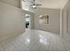 Spacious bedroom featuring tile flooring, neutral paint, and a large window overlooking a lush, tropical yard at 8812 Bayaud Dr, Tampa, FL 33626