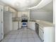 Functional kitchen with white cabinets, stainless steel appliances, and ample countertop space at 8812 Bayaud Dr, Tampa, FL 33626