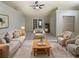 Bright living room with a cozy rug, neutral furniture, and sliding doors leading to the backyard at 8812 Bayaud Dr, Tampa, FL 33626