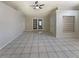Open-concept living area features tile flooring, high ceilings, and access to the backyard through sliding doors at 8812 Bayaud Dr, Tampa, FL 33626