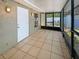 Covered, screened-in patio with a tile floor and exterior access door at 8812 Bayaud Dr, Tampa, FL 33626