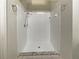 Bright, clean, tiled walk-in shower with chrome fixtures and a marble-look accent base at 8812 Bayaud Dr, Tampa, FL 33626