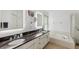 A luxurious bathroom featuring double sinks, granite countertops, and a soaking tub for ultimate relaxation at 892 Crestridge Cir, Tarpon Springs, FL 34688