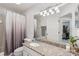 Clean and functional bathroom with a granite countertop, a shower, and ample mirror space for grooming at 892 Crestridge Cir, Tarpon Springs, FL 34688