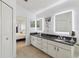 Spacious bathroom featuring double sinks, granite countertops, and stylish lighting fixtures at 892 Crestridge Cir, Tarpon Springs, FL 34688