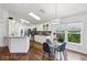 Bright kitchen and eat-in dining area with white cabinets, stainless appliances, and hardwood floors at 892 Crestridge Cir, Tarpon Springs, FL 34688