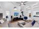 Inviting living room with hardwood floors, comfortable seating, a modern entertainment center, and lots of light at 892 Crestridge Cir, Tarpon Springs, FL 34688