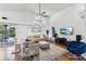 Bright and airy living room with hardwood floors, modern furnishings, and access to the patio at 892 Crestridge Cir, Tarpon Springs, FL 34688