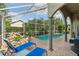 Inviting screened pool area with rock waterfall feature for outdoor relaxation and leisure at 892 Crestridge Cir, Tarpon Springs, FL 34688