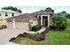 Charming single-story home with a well-manicured lawn and a two-car garage at 10908 Sailbrooke Dr, Riverview, FL 33579