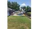 Spacious backyard with lush lawn, cozy patio seating area, and a unique stock tank pool for relaxation at 10142 118Th Ave, Largo, FL 33773