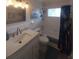 Bright bathroom with white tiled walls, modern vanity, and decorative ocean-themed artwork at 10142 118Th Ave, Largo, FL 33773