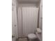 Clean bathroom featuring a shower with white shower curtain, toilet, and neutral color scheme at 10142 118Th Ave, Largo, FL 33773
