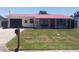 Charming home featuring a well-maintained front yard and a distinctive red metal roof at 10142 118Th Ave, Largo, FL 33773