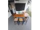 Outdoor bar area with wooden countertop, metal base, and seating for four at 10142 118Th Ave, Largo, FL 33773