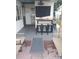 Covered outdoor bar with seating, fan, lighting, and patio furniture on brick pavers at 10142 118Th Ave, Largo, FL 33773