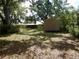 Tranquil backyard featuring a storage shed and ample space for recreation at 10308 Fore Dr, Tampa, FL 33612