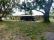 Spacious backyard featuring a patio, mature trees, and ample space at 10308 Fore Dr, Tampa, FL 33612