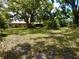 Spacious backyard featuring a detached garage and plenty of greenery at 10308 Fore Dr, Tampa, FL 33612