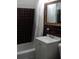 Bathroom with a bath tub, sink, and window at 10308 Fore Dr, Tampa, FL 33612